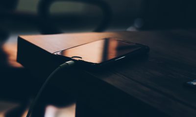 Shallow Focus Photography of Black Iphone 7 on Brown Wooden Table