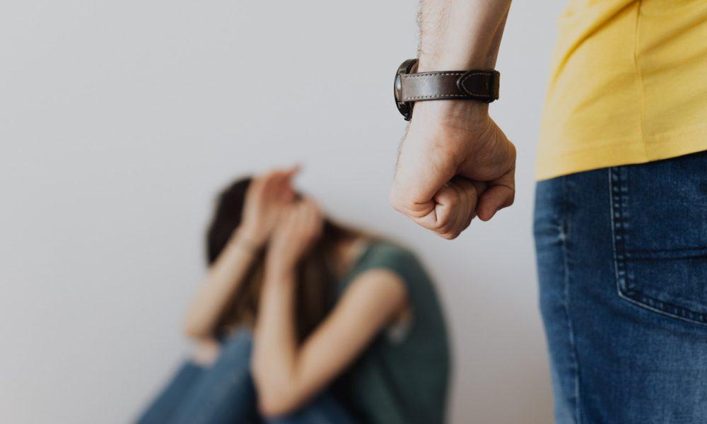 man clenching fist near woman