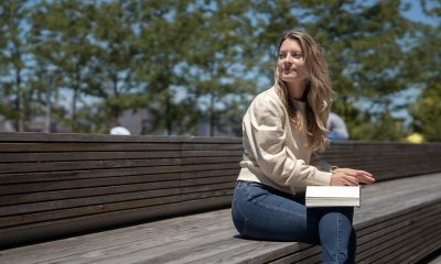 woman sitting on bench under the sand