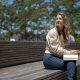 woman sitting on bench under the sand