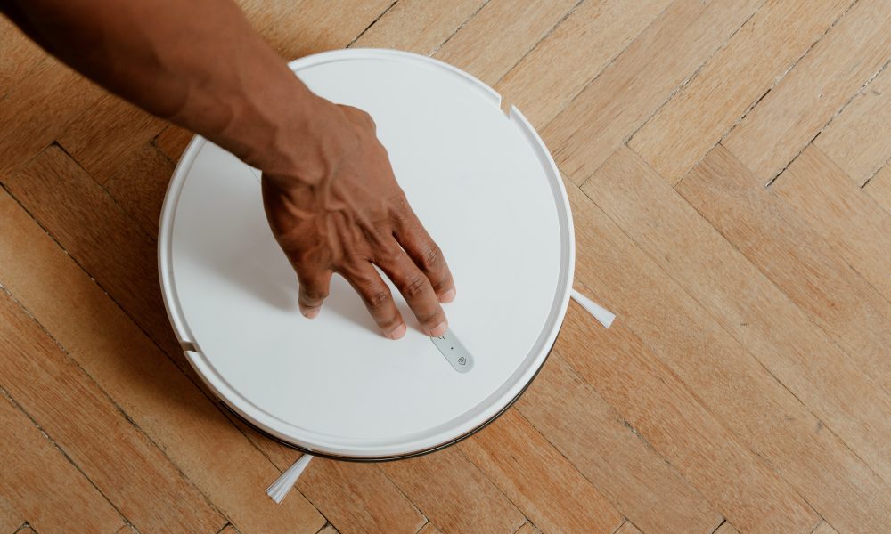 Man Touching Cleaning Robot