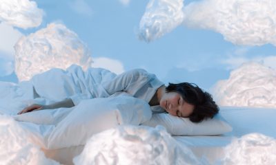 Photo of a Woman Sleeping Near Fluffy Clouds