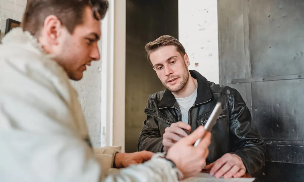 men looking at phone