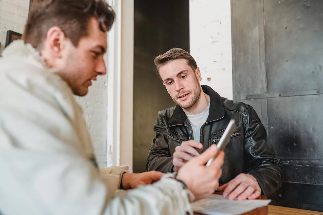 men looking at phone