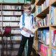 Boy in White Long Sleeve Shirt in the Library