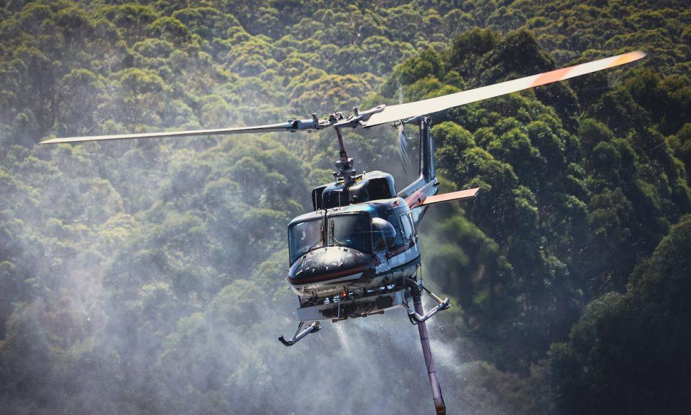 Helicopter Flying above Forest