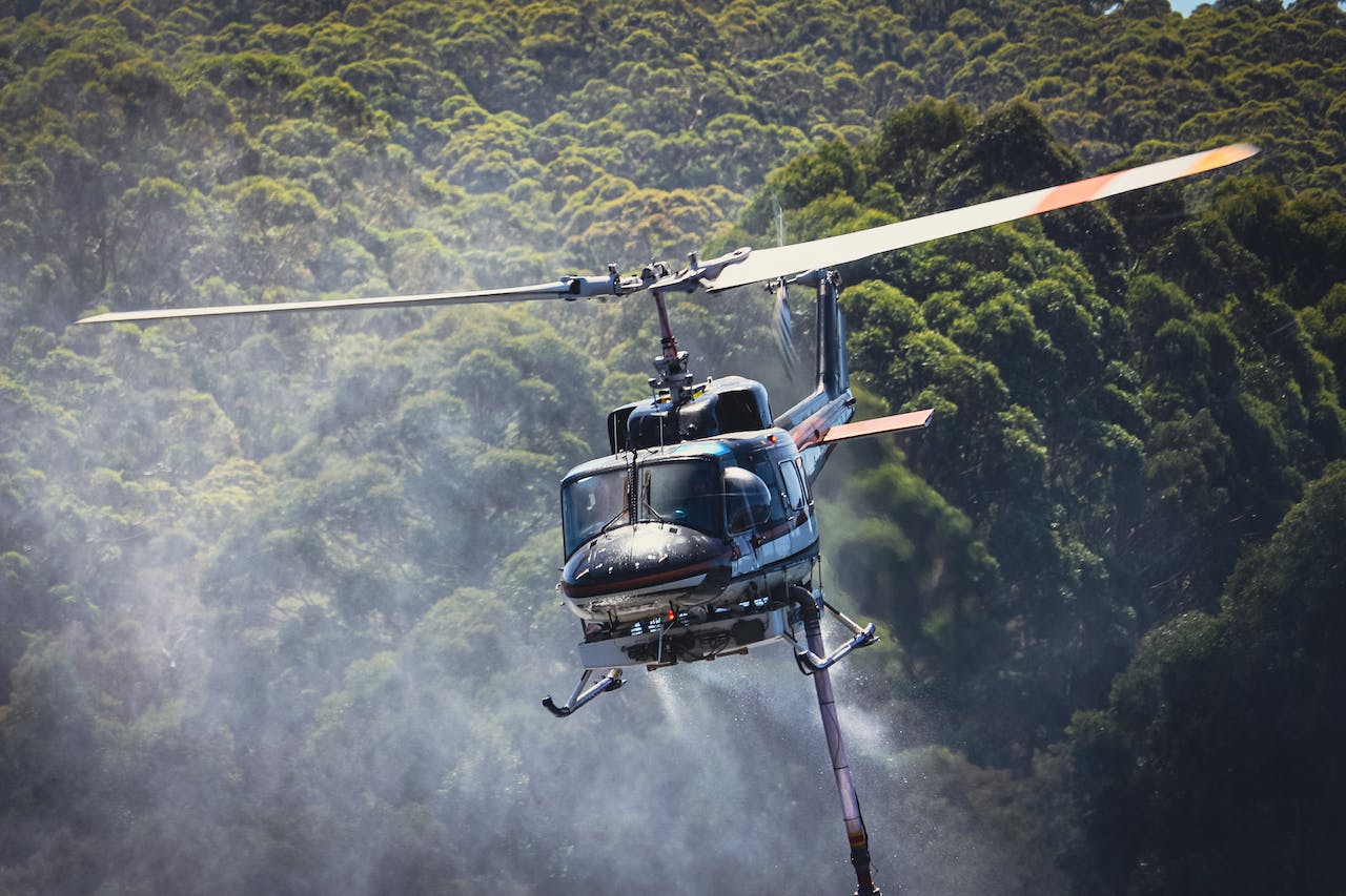 Helicopter Flying above Forest