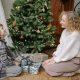 Mother And Son Sitting By A Christmas Tree