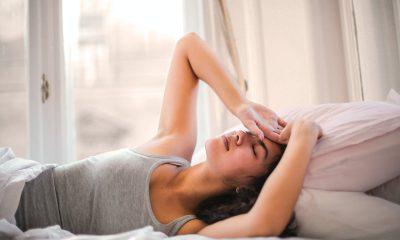 Woman in Gray Tank Top Lying on Bed