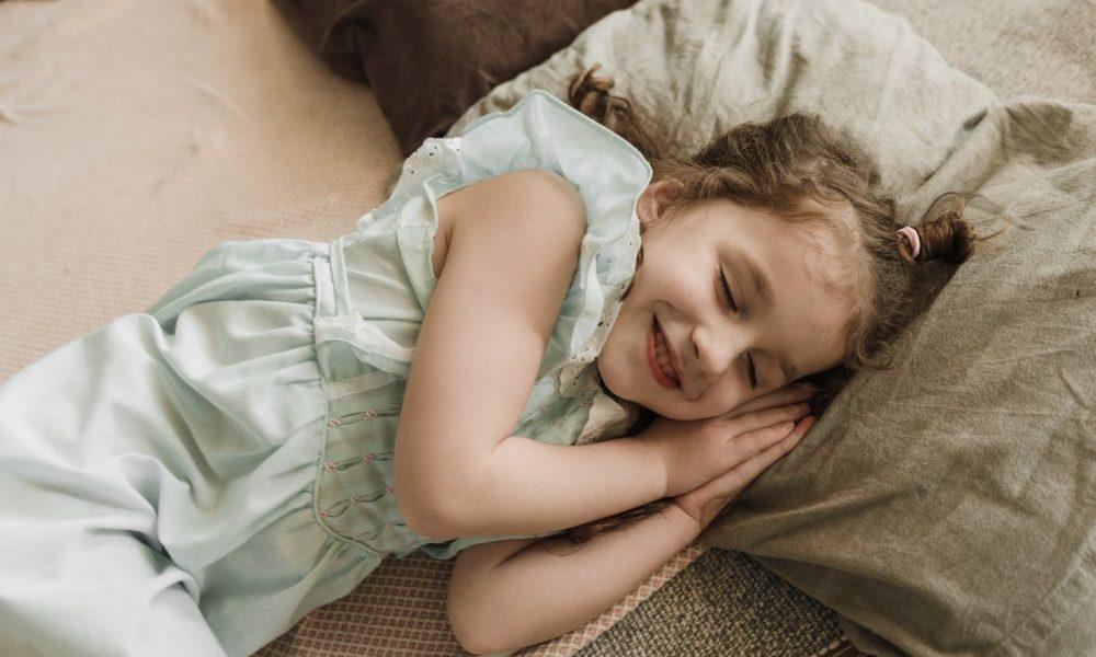 sleeping kid on bed