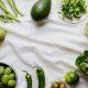 Green Vegetables and Fruits on a White Surface