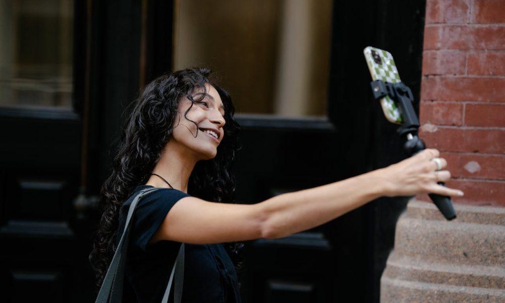 Woman Taking Selfie on Street