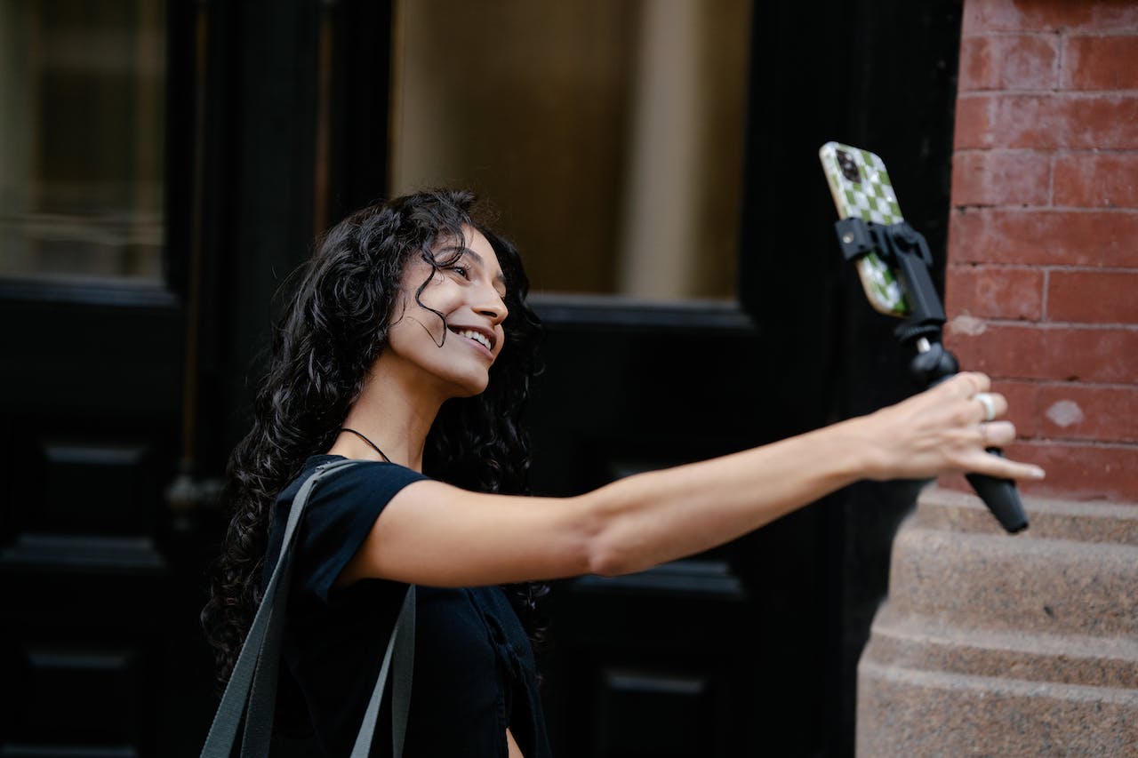 Woman Taking Selfie on Street