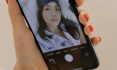 Close-up of a Smartphone Screen Displaying a Woman Taking a Selfie