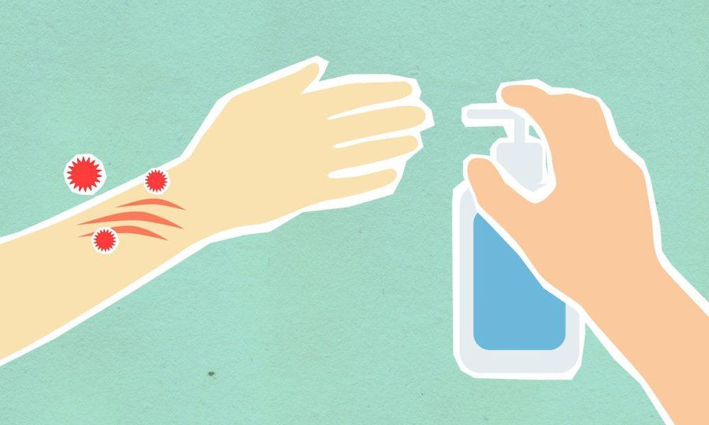 Paper cutout of person disinfecting hands