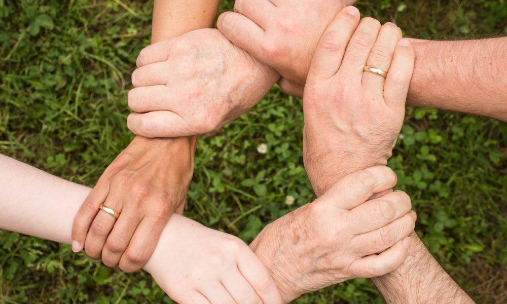 https://www.pexels.com/photo/group-of-people-holding-arms-461049/