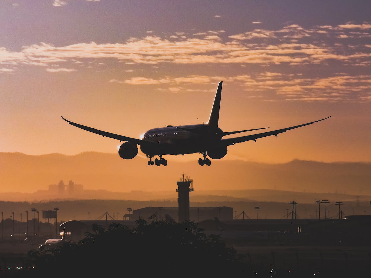 silhouette of landing airplane