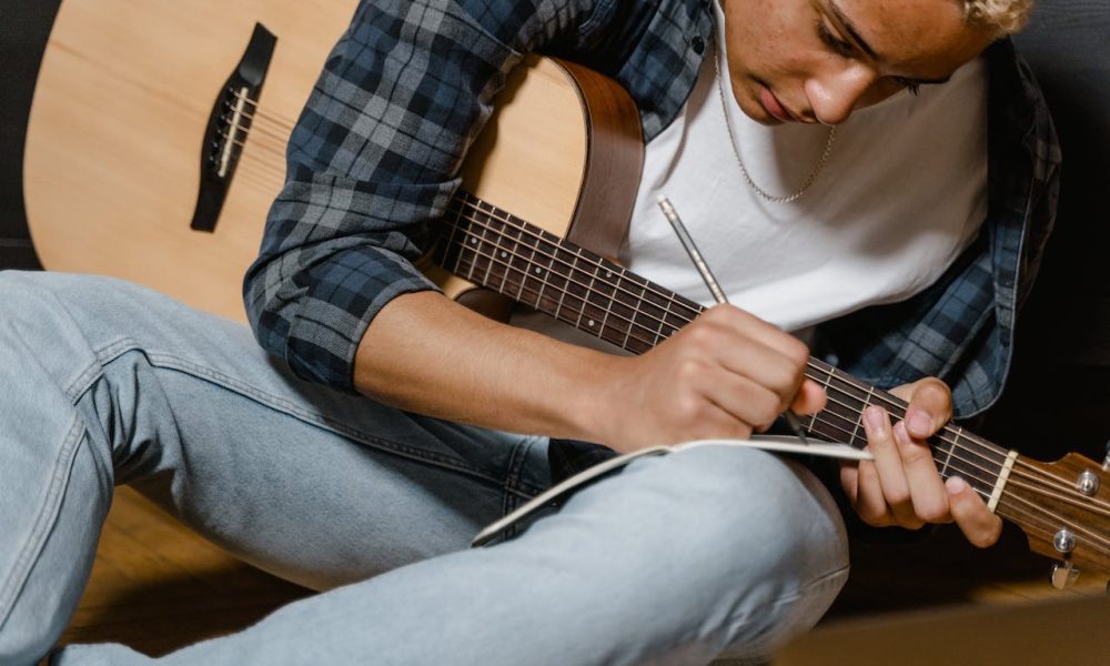 writing song with guitar