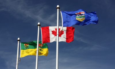 From left to right, the flags of Saskatchewan, Canada, and Alberta flying together in Lloydminster, Saskatchewan/Alberta