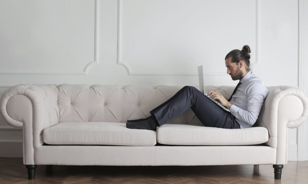 Photo Of Man Sitting On Couch