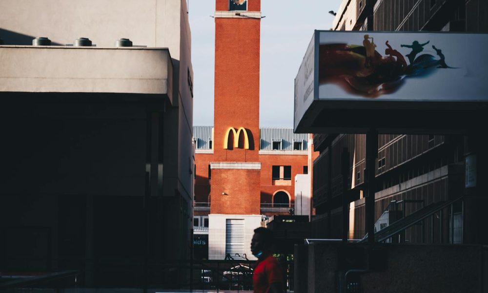 Man Walking Past McDonald's Sign