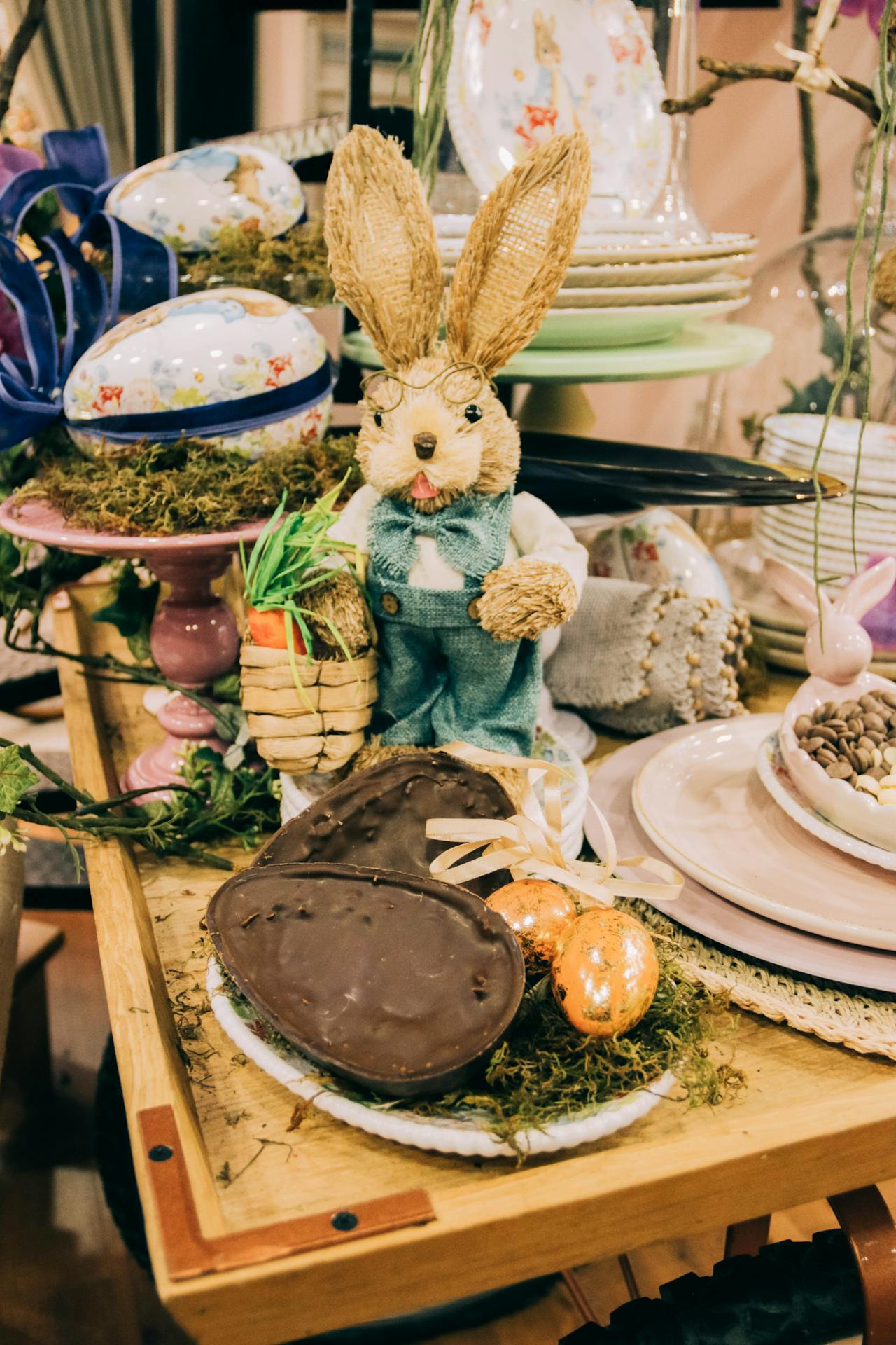 easter bunny with easter chocolate eggs on table