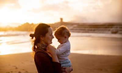 Shallow Focus Photo of Mother Carrying Her Baby