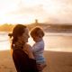 Shallow Focus Photo of Mother Carrying Her Baby