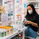 lady checking medicine bottles in a pharmacy