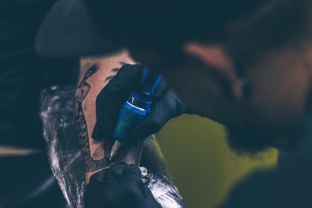 man tattooing person