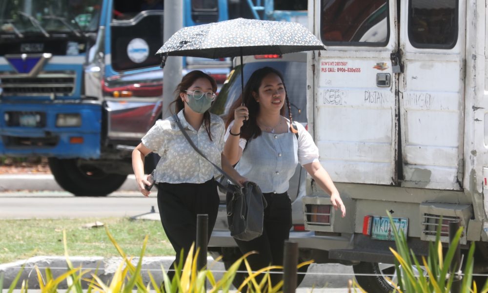 women walking under the heat