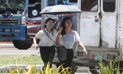 women walking under the heat