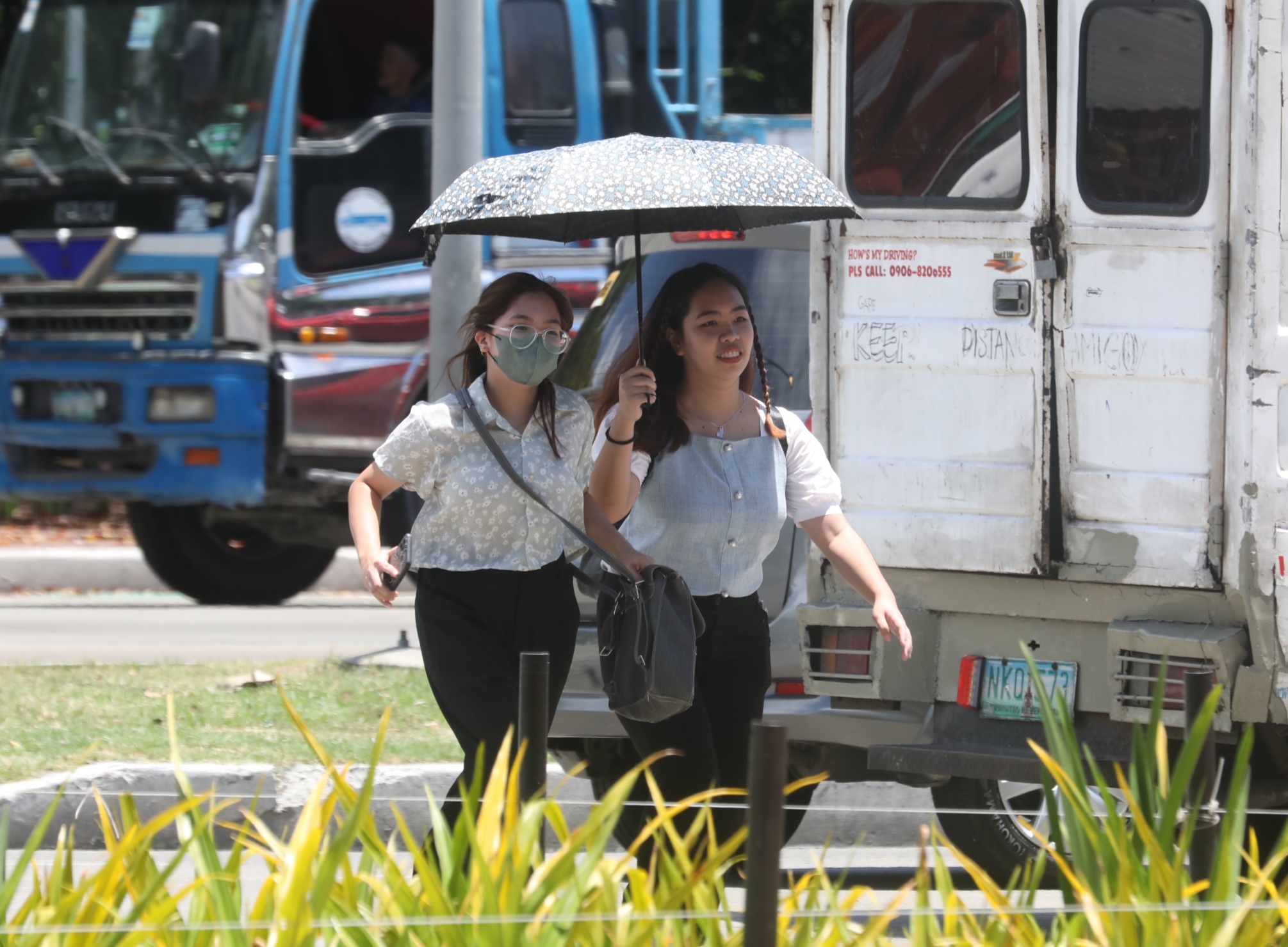 women walking under the heat