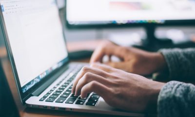 hands typing at laptop