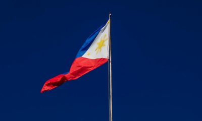 Flag on flagpole against cloudless sky