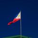 Flag on flagpole against cloudless sky