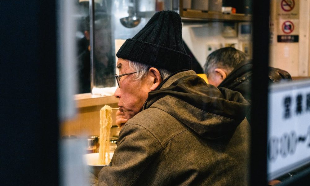 man eating noodles