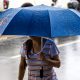 woman holding umbrella raining