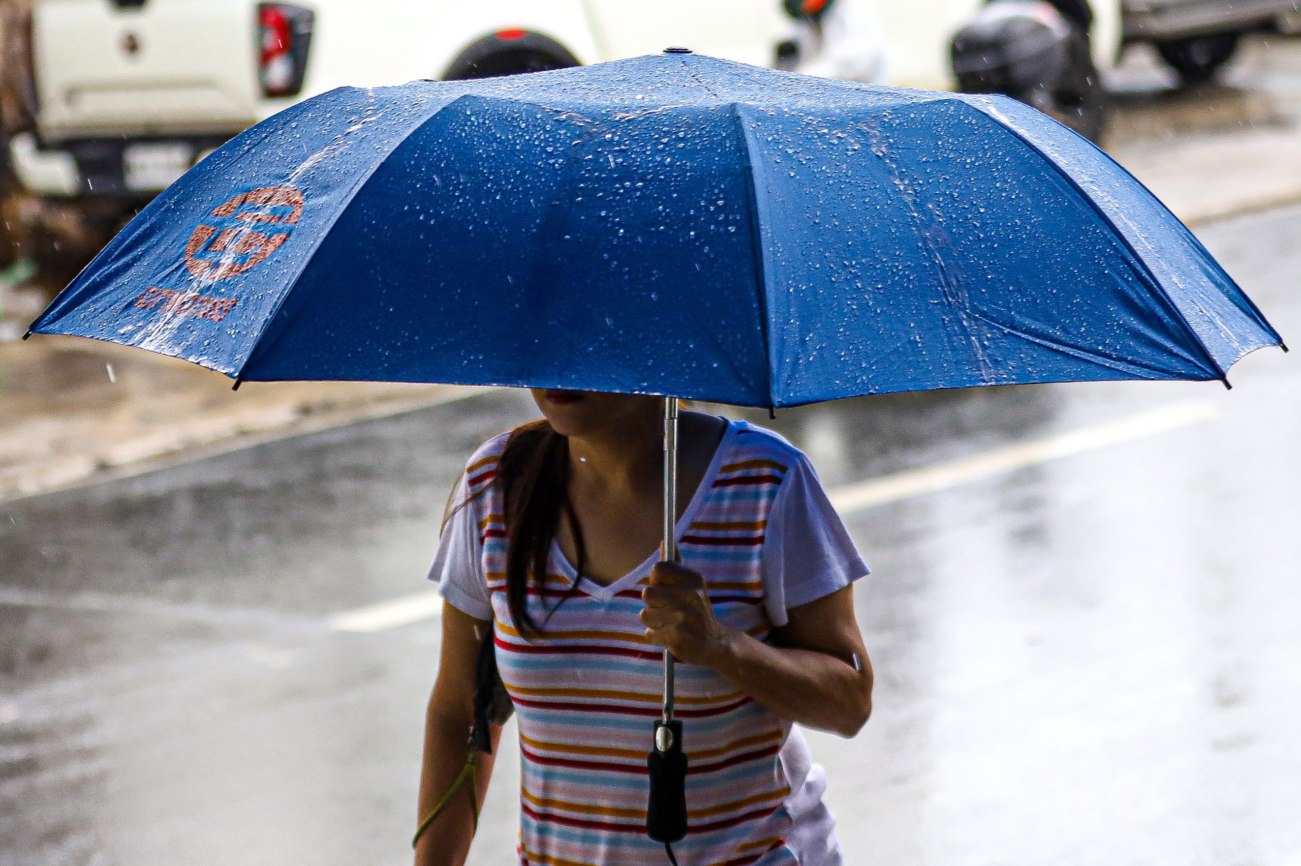 woman holding umbrella raining
