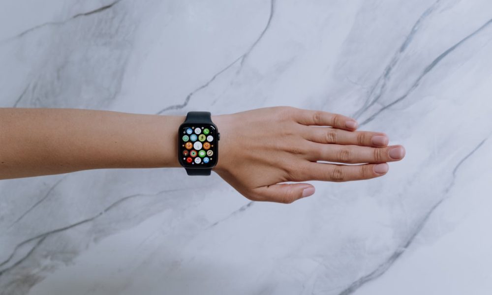 Person Wearing Silver Aluminum Case Apple Watch With Black Sport Band