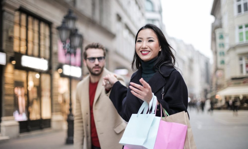 Woman in Black Coat Holding a Shopping Bags