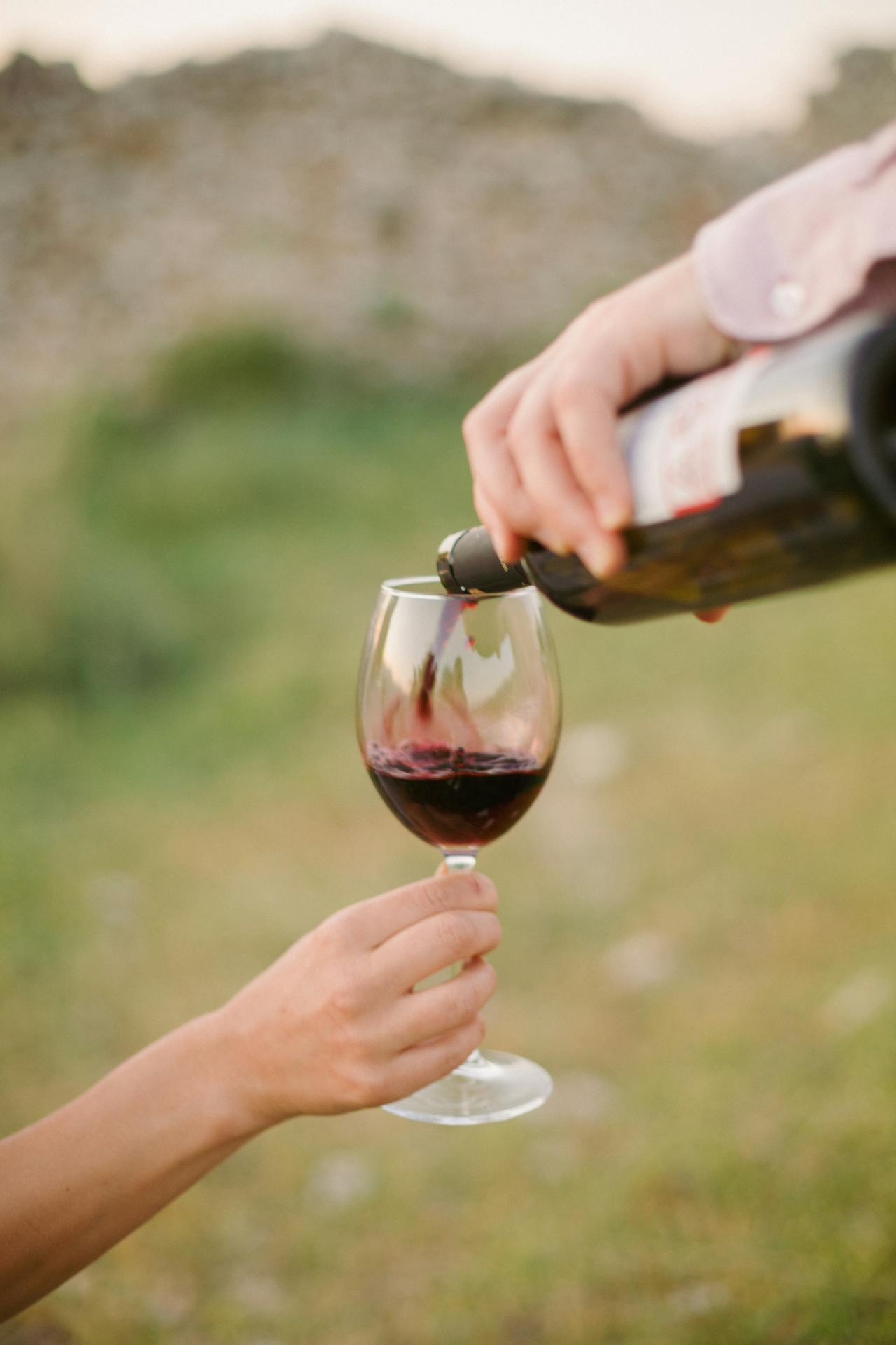 pouring wine on glass