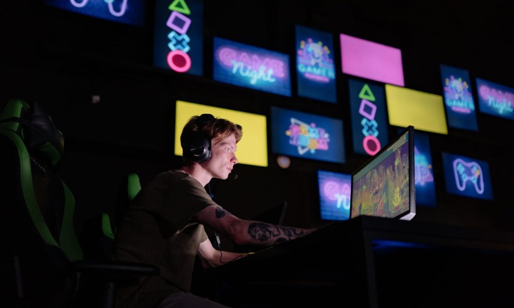 man playing video game on computer