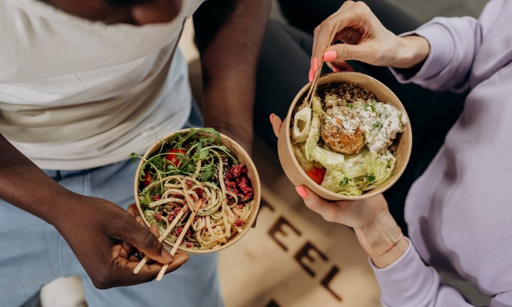 man and woman eating healthy foods