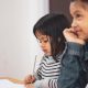 Two Girls Writing on Paper