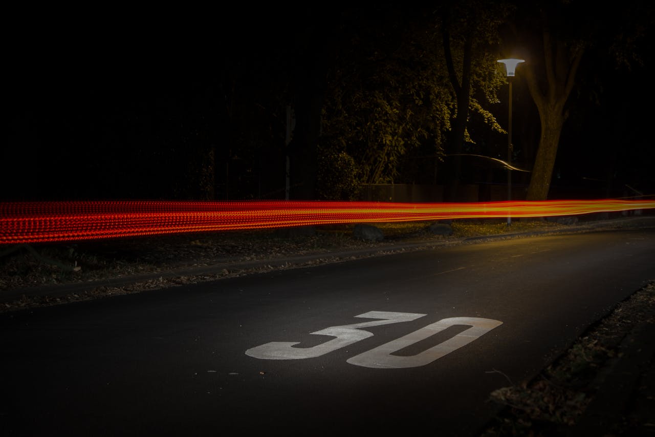 Time Lapse Photography of Red and Orange Light on Road With 30 Print on Nighttime